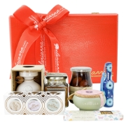 Red pine wooden gift box with a swing lid filled with Greek gourmet food products.