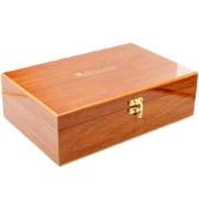 Closed polished mahogany wooden gift box with elegant Elenianna gold logo and brass clasp. Premium packaging for luxury Greek corporate gifts and Chios mastiha sets.