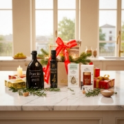 A luxury Cretan food hamper styled as a festive corporate gift in a modern kitchen with marble countertops.