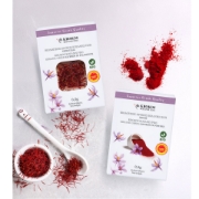Top view comparison of Krokos Kozanis Organic Greek Saffron Filaments and Saffron Powder packages with loose red threads and vibrant red powder