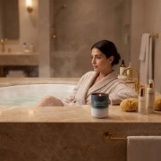 Aurean luxury scented candle spa bathroom wellness scene woman relaxing bathtub premium Greek candle aromatherapy ambiance