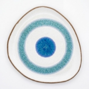 Handmade organic-shaped ceramic plate featuring a turquoise and blue Aegean eye design on white stoneware.